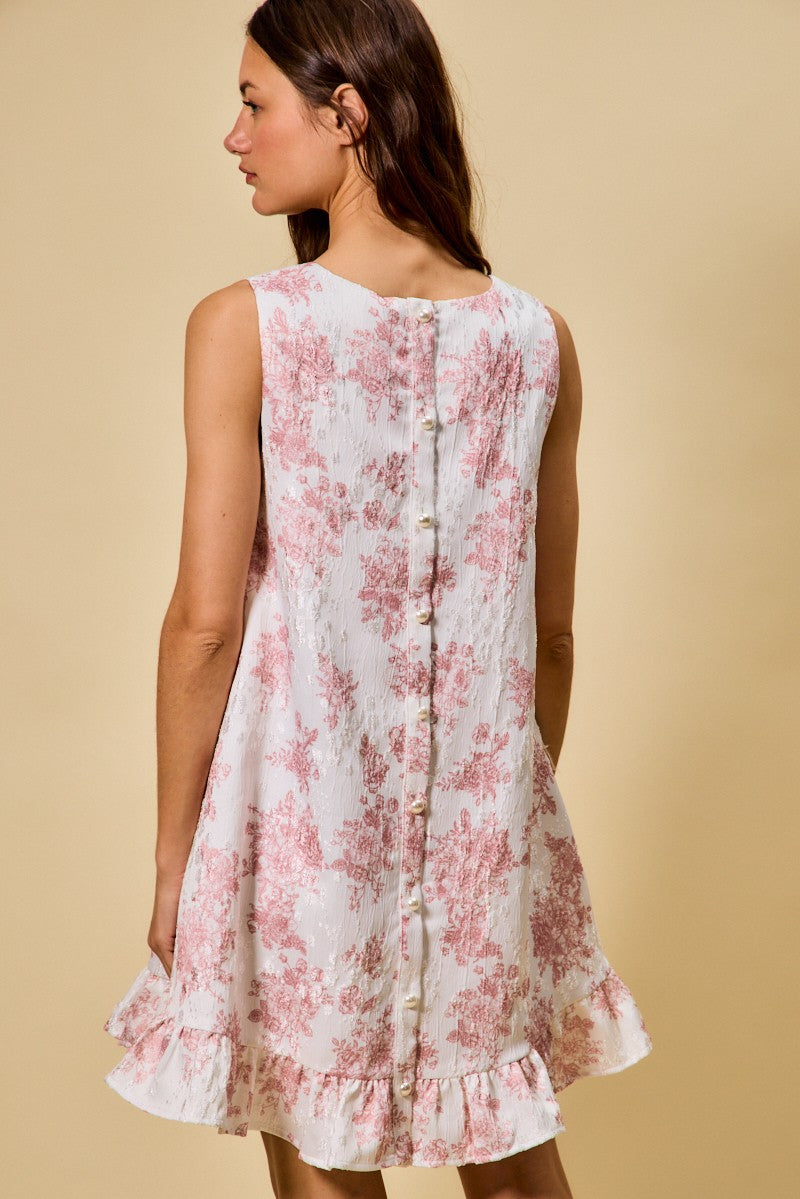 Woman wearing a floral dress against a beige background