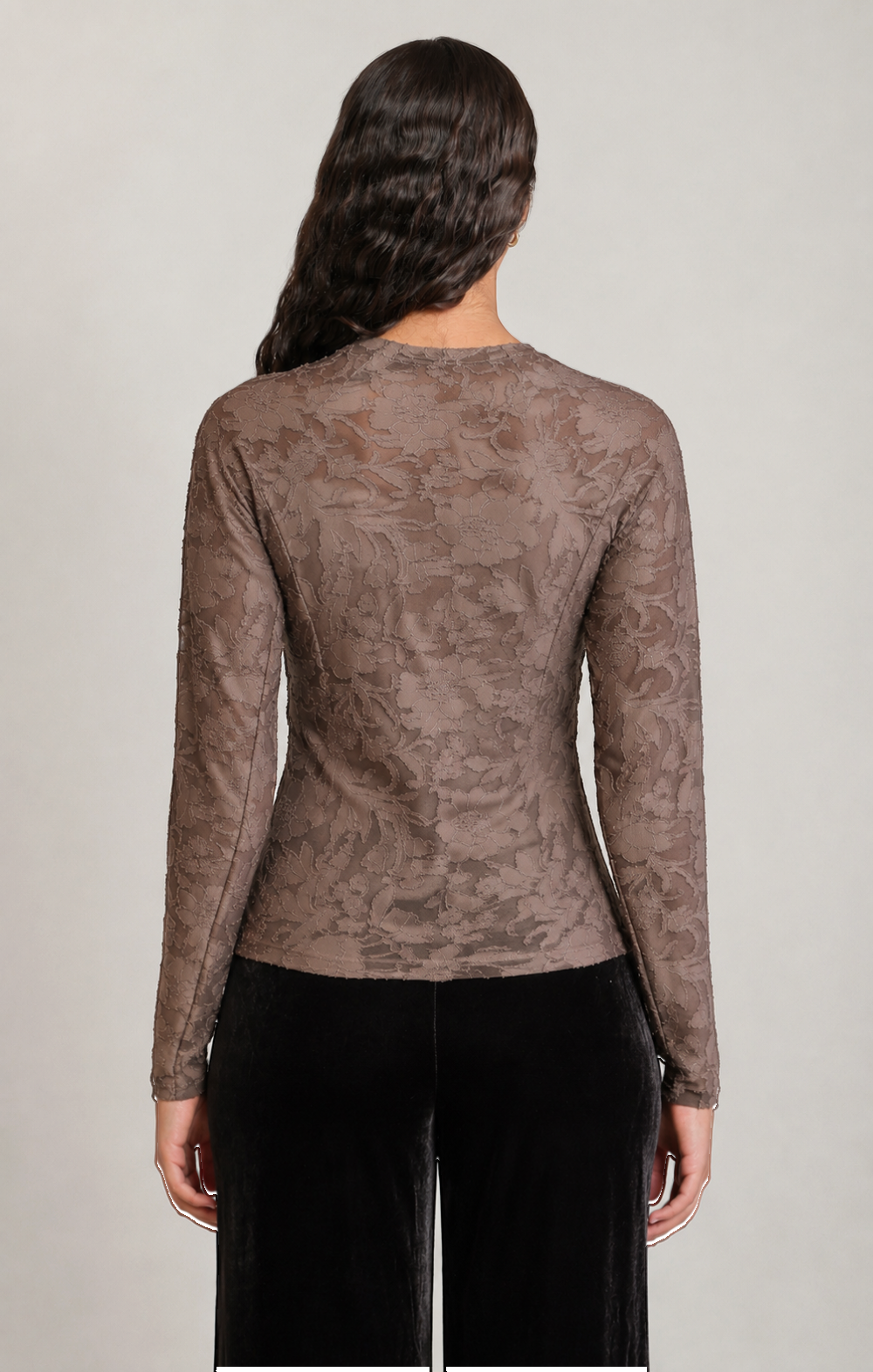 Apricot Lane Duluth long sleeve floral top in taupe with a textured stretch fabric worn by a model from the back.