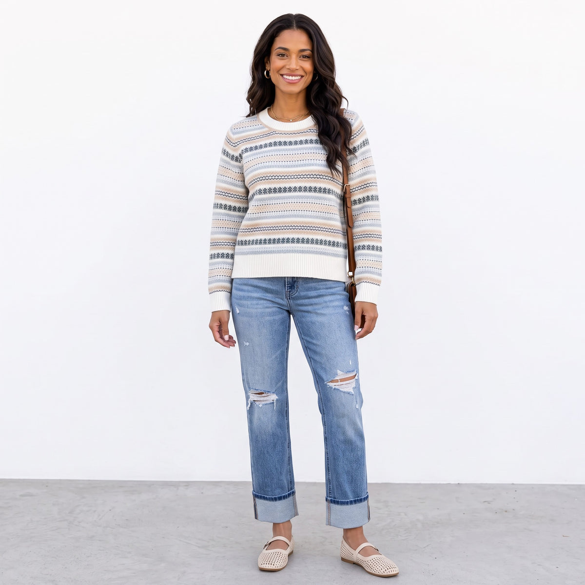 Apricot Lane Duluth Fair Isle sweater in ivory with evergreen, blue, and taupe stripes, worn with distressed jeans.