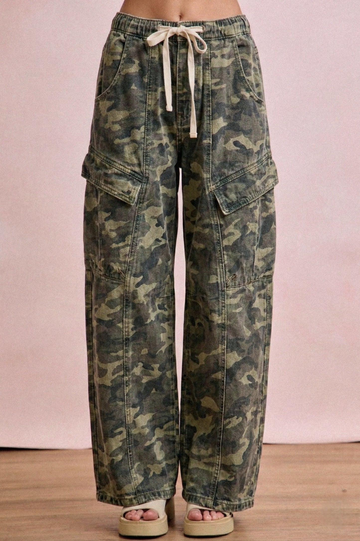 Camouflage cargo pants on a pink background
