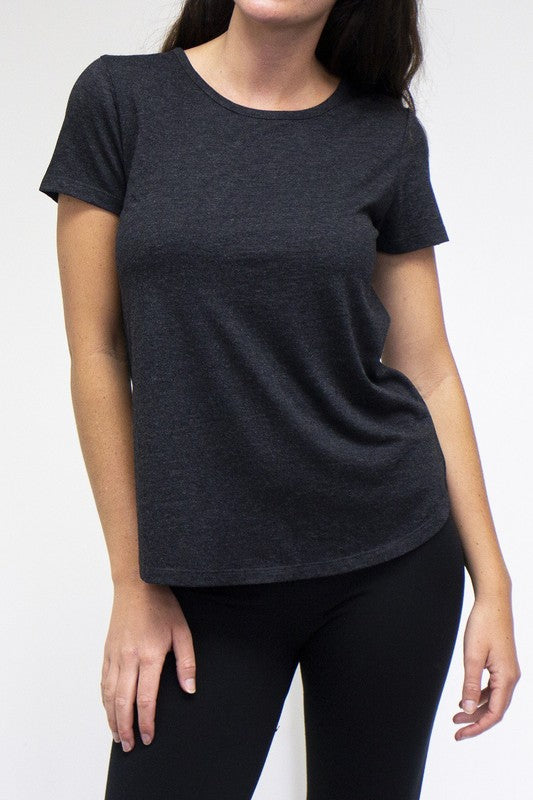 Person wearing a dark gray t-shirt and black leggings on a white background