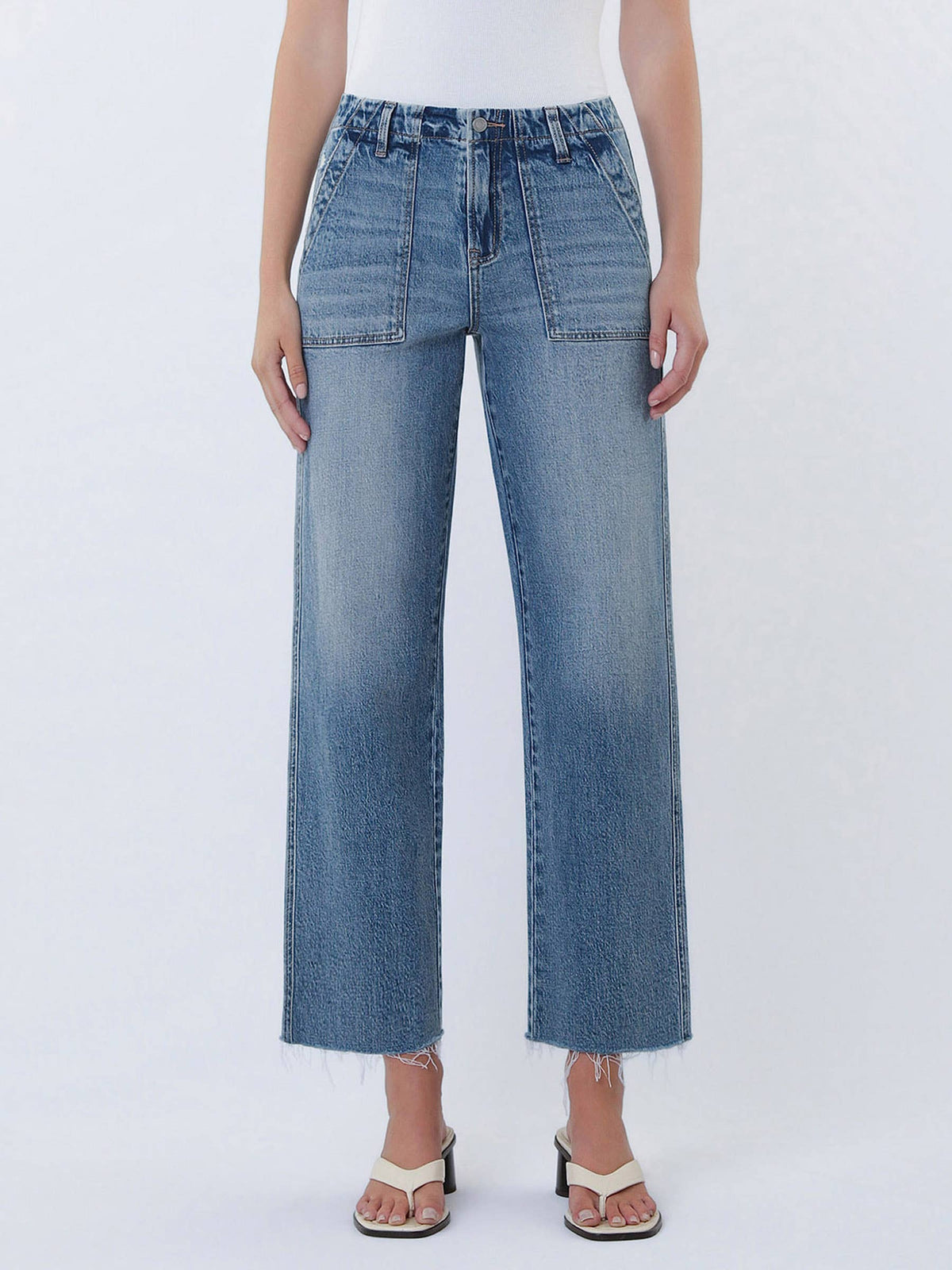 Person wearing blue jeans on a white background