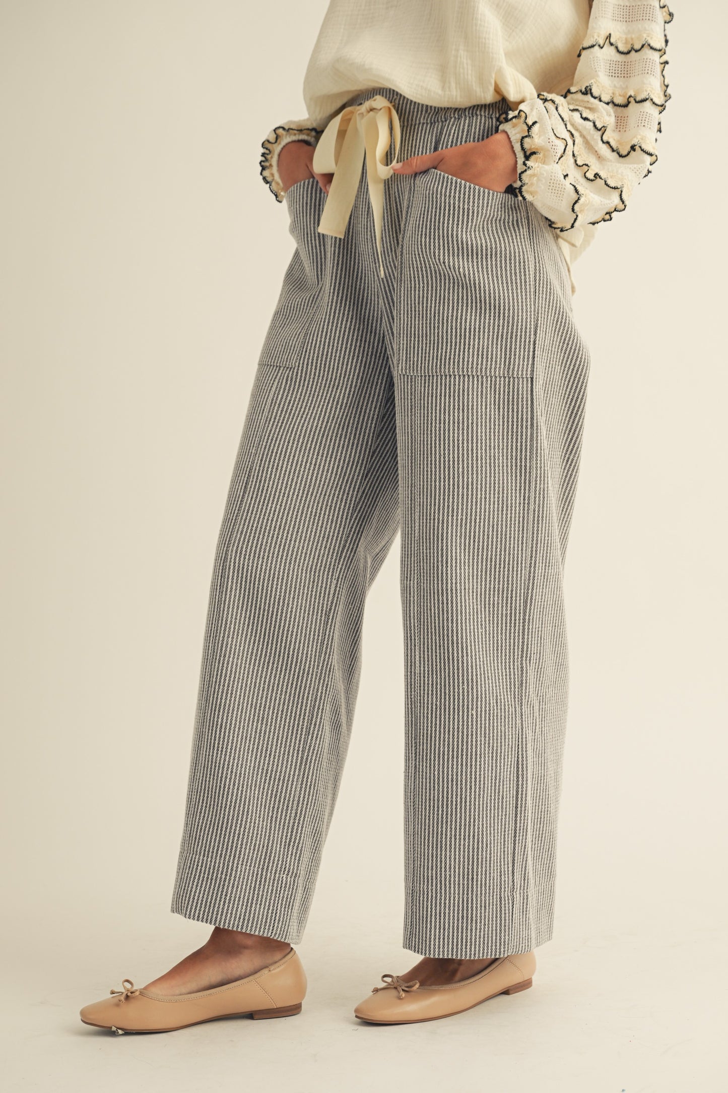 Person wearing checkered pants with a plain background