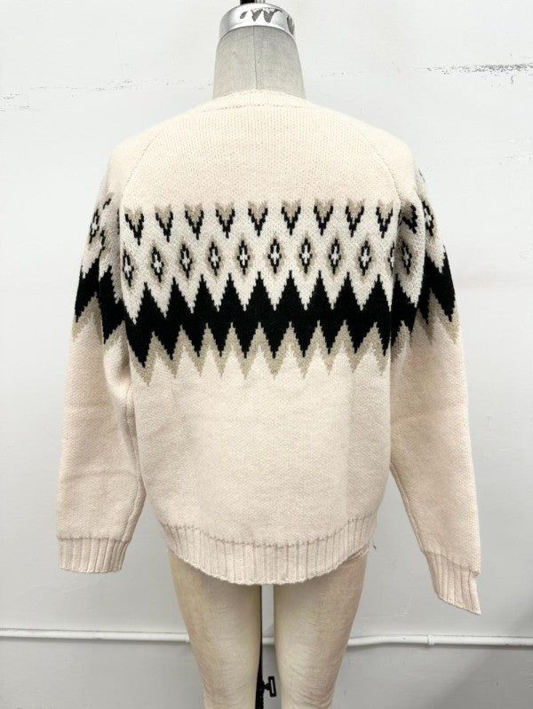 Cream knit sweater with a black and beige geometric Fair Isle pattern across the shoulders and upper back, displayed on a dress form mannequin against a white wall.