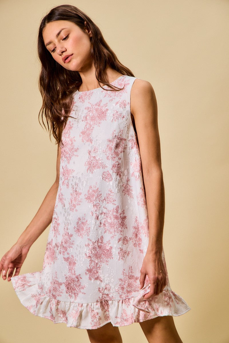 Woman wearing a floral dress against a beige background