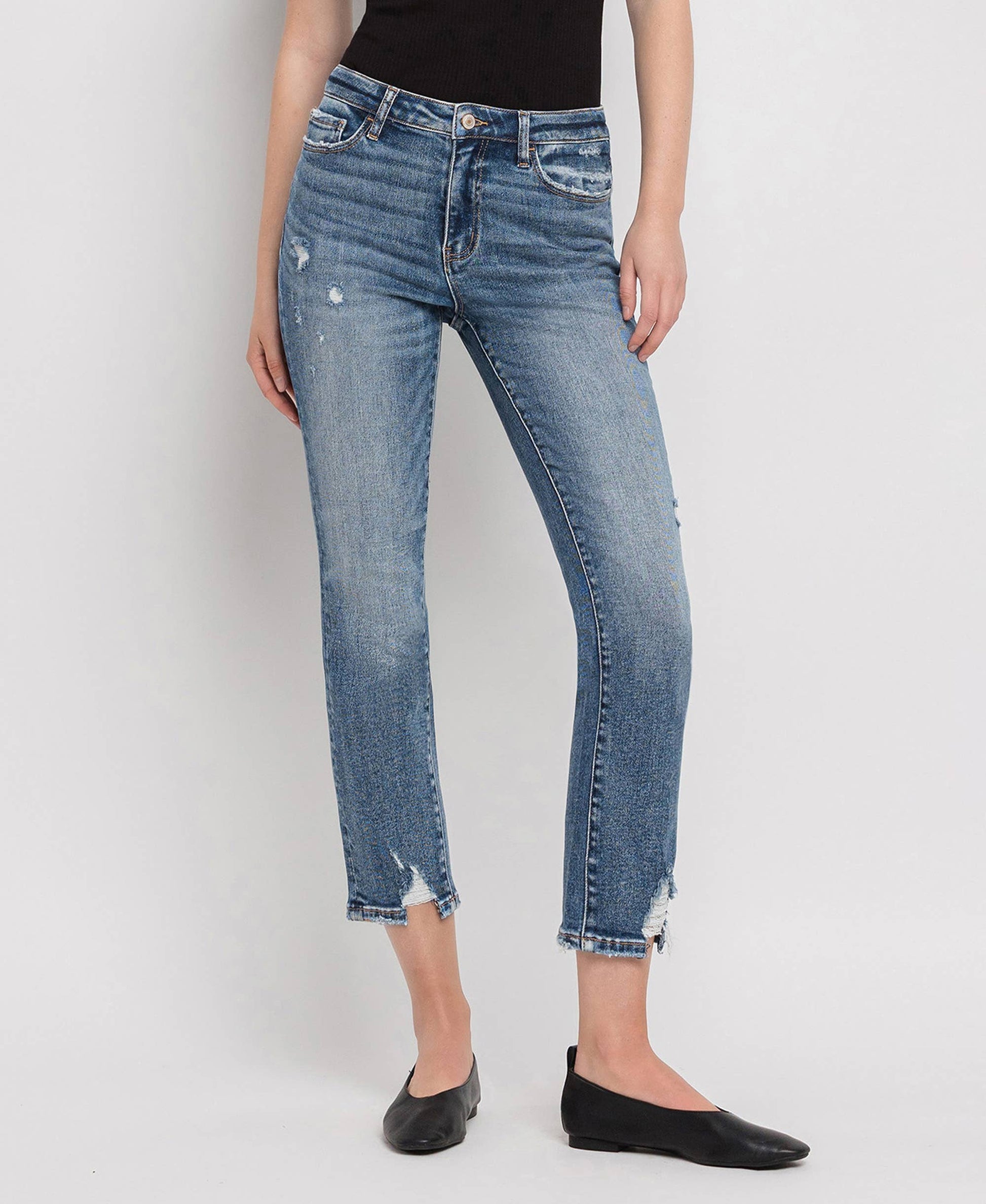 Person wearing blue jeans on a white background