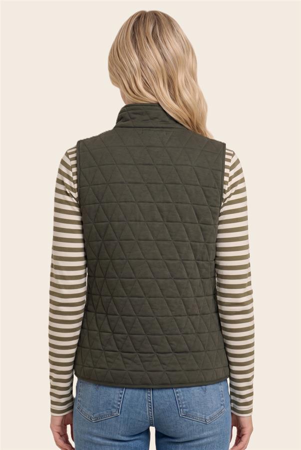 A woman viewed from the back wearing an olive green diamond-quilted sleeveless puffer vest over a beige and brown striped long-sleeve shirt and blue jeans, against a solid light beige background.