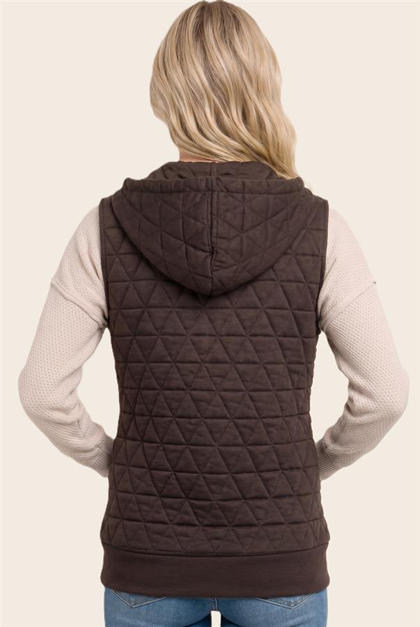 A woman shown from the back wearing a dark brown diamond-quilted sleeveless hooded vest over a light beige long-sleeve knit top and blue jeans, against a solid light beige background.