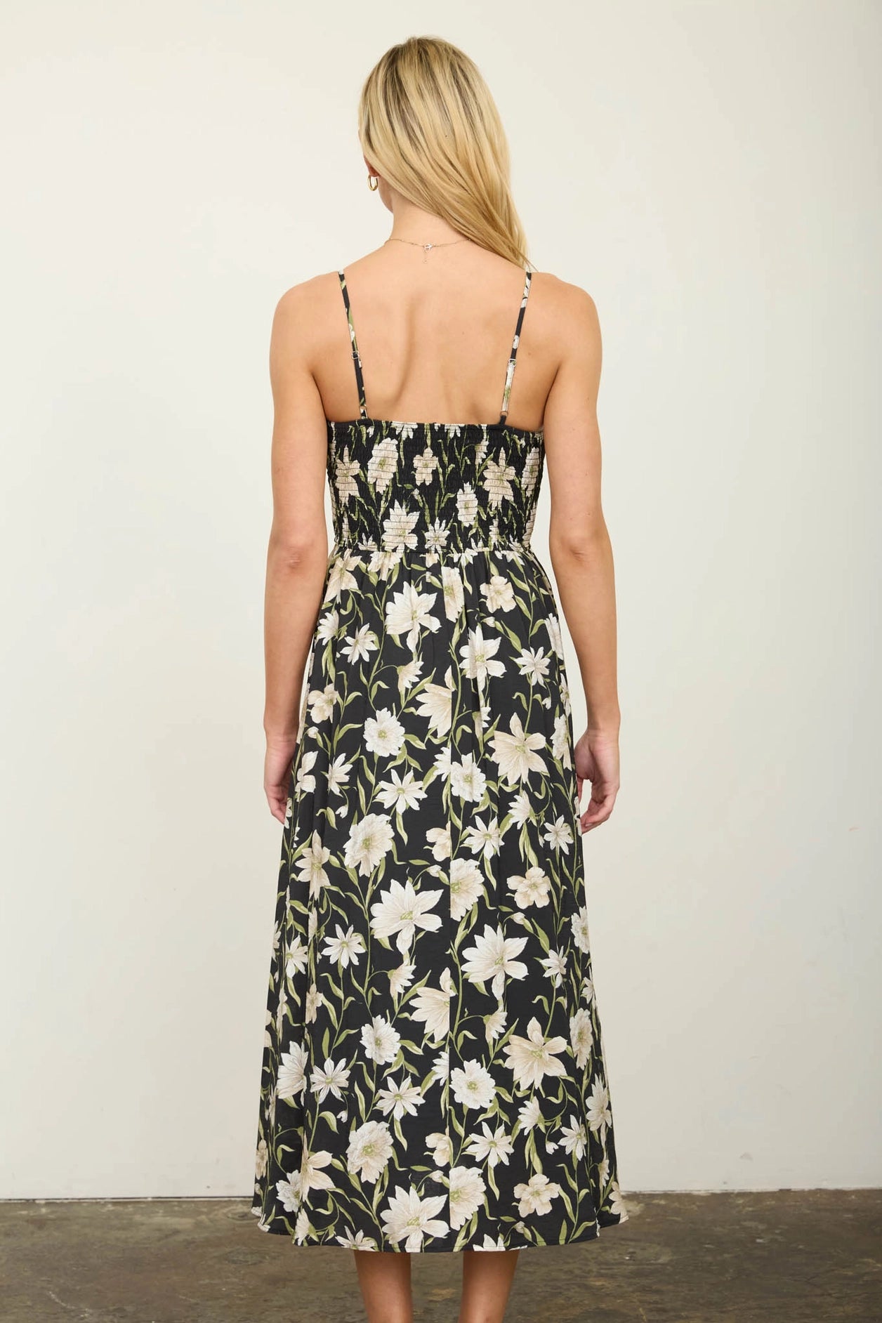 Woman wearing a floral dress with a plain background