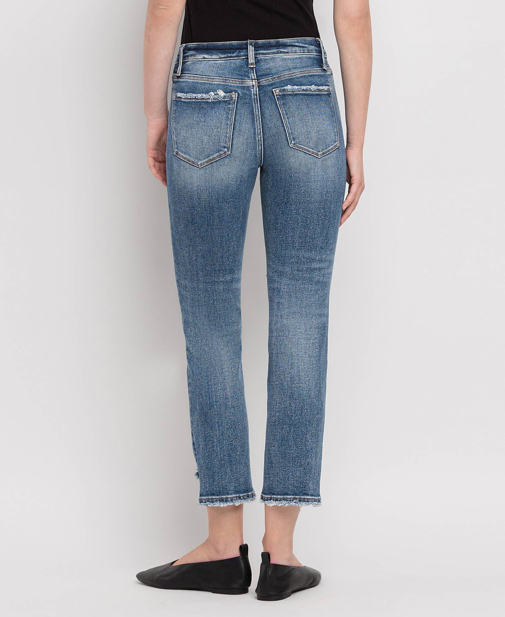 Person wearing blue jeans on a white background