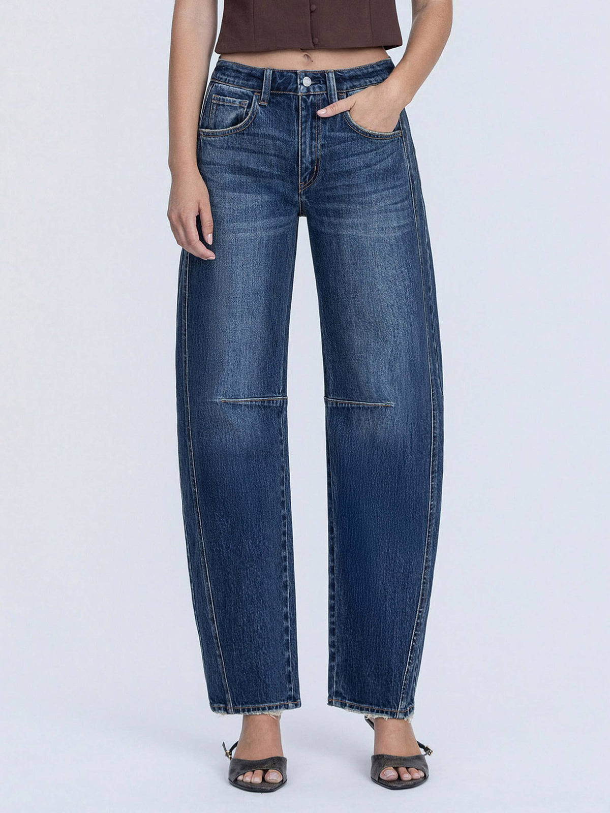 Person wearing blue jeans on a white background