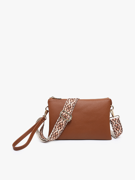 Brown leather handbag with a patterned strap on a white background