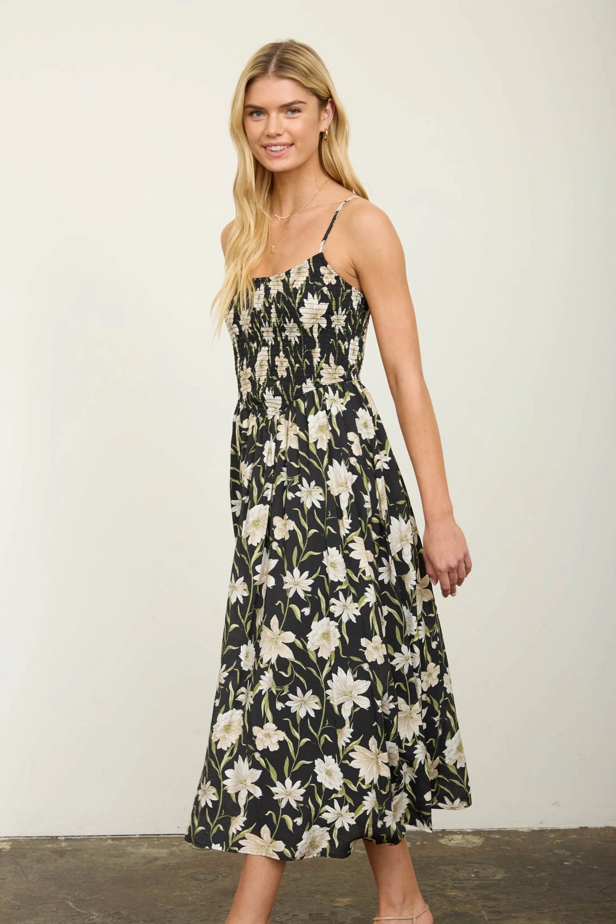 Woman wearing a floral dress against a plain background