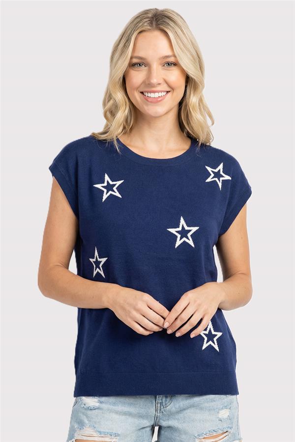 Woman wearing a navy blue t-shirt with white star patterns on a plain background