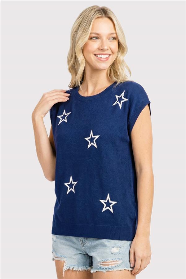 Woman wearing a navy blue t-shirt with white stars on a plain background