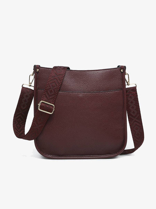 Brown leather crossbody bag on a white background