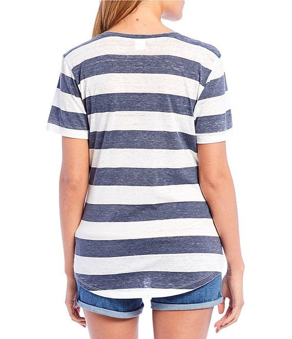 Person wearing a blue and white striped t-shirt with shorts on a white background