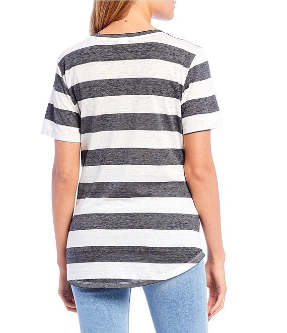 Person wearing a black and white striped t-shirt on a white background