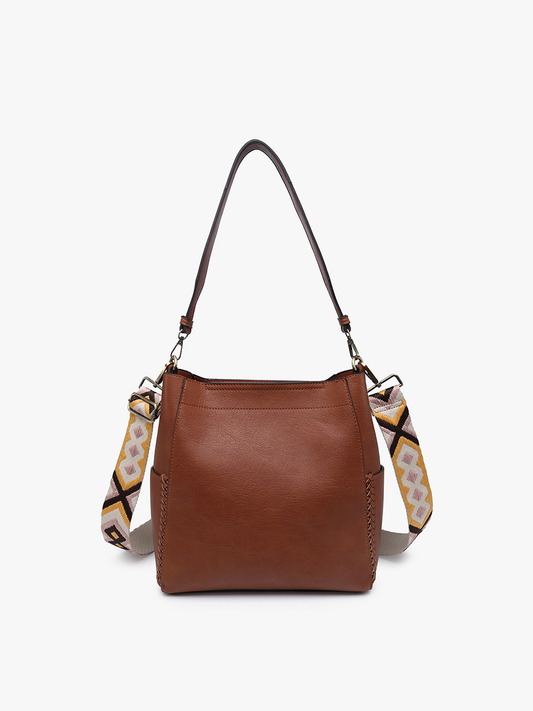 Brown leather handbag with a patterned strap on a white background