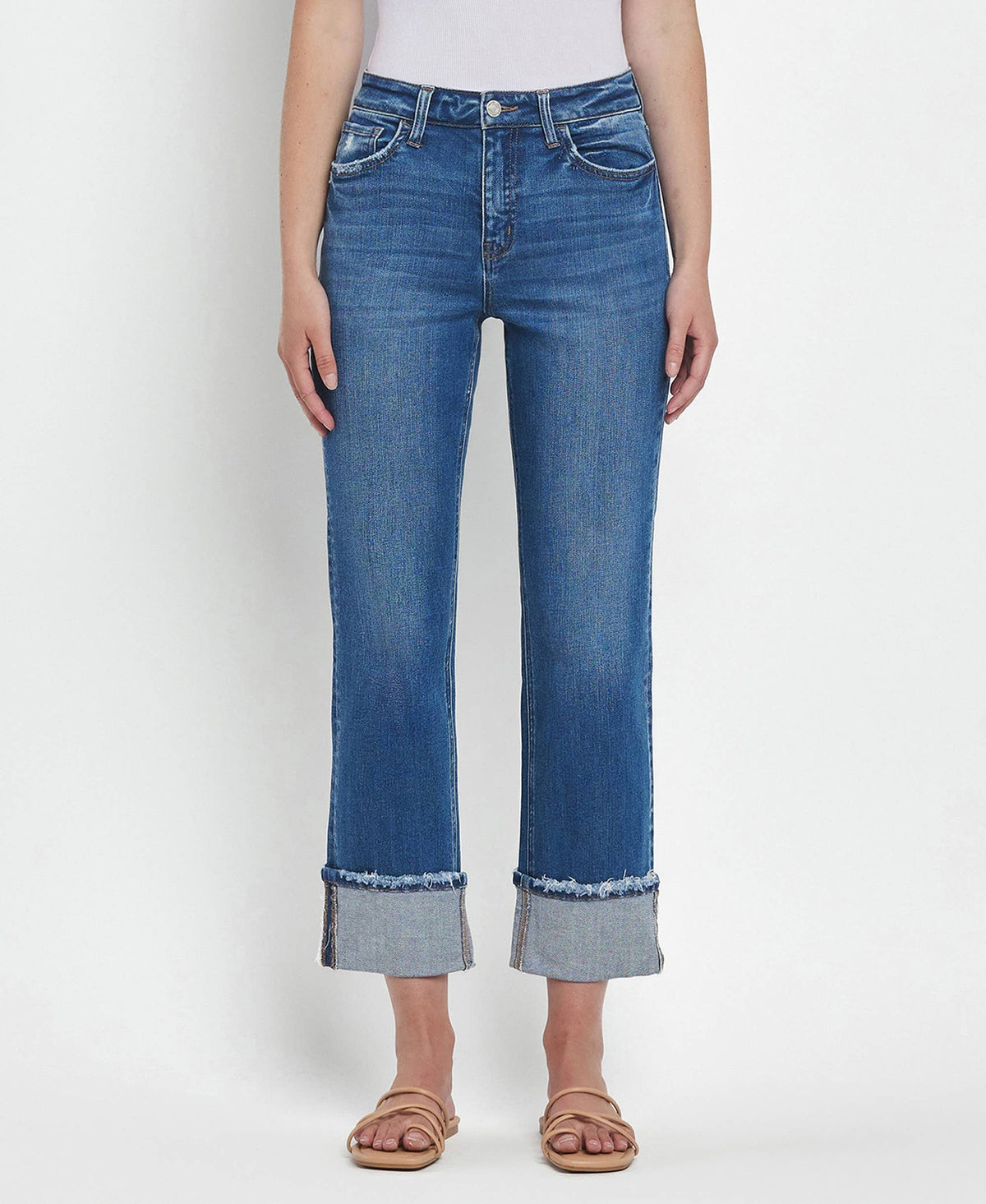 Blue jeans with rolled-up cuffs on a white background