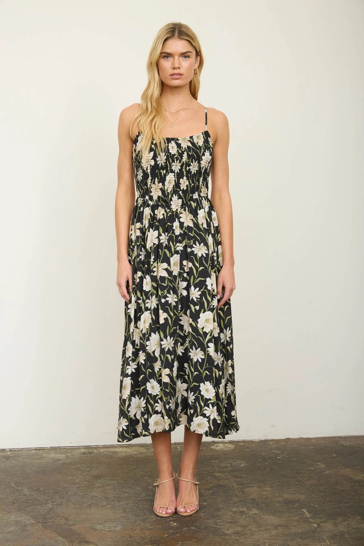 Woman wearing a floral dress against a plain background