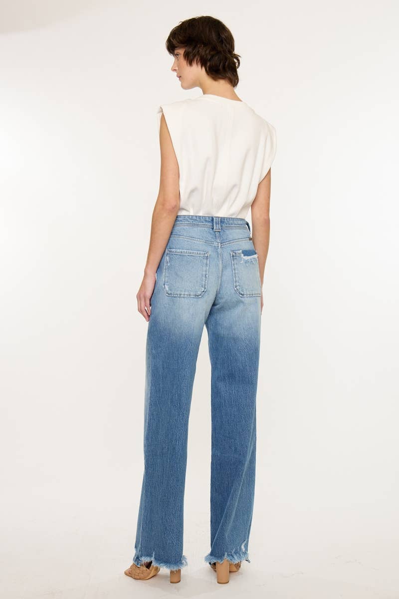 Woman wearing blue jeans and a white top on a white background
