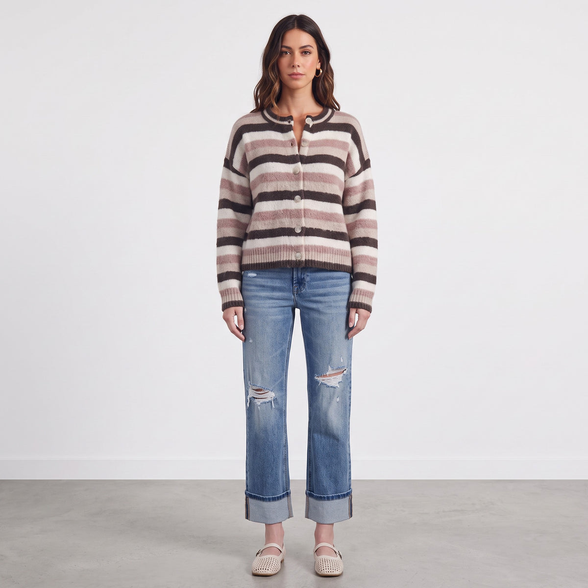 Model wearing Apricot Lane Duluth Sophie soft striped button-front cardigan with blue distressed denim jeans
