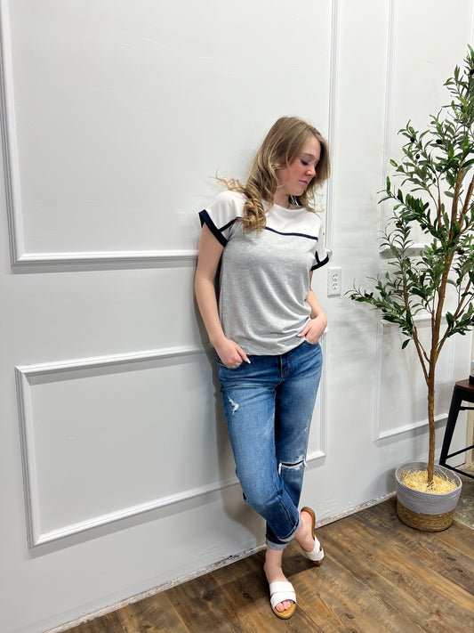 Person lying on a white floor with a plant in the background
