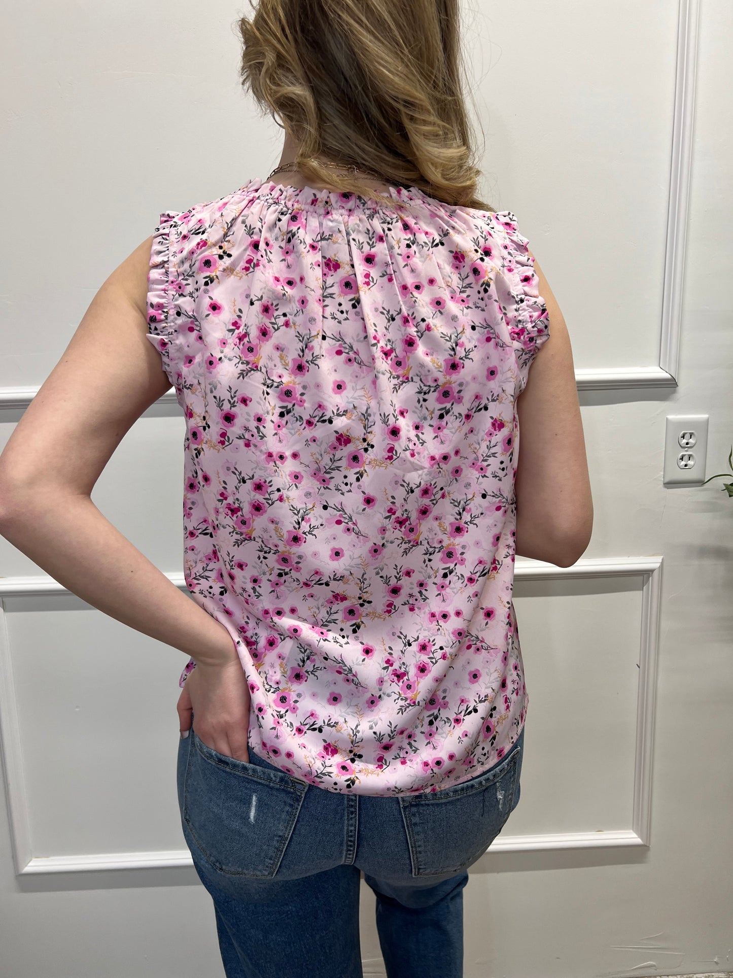 Person wearing a pink floral dress with a white background