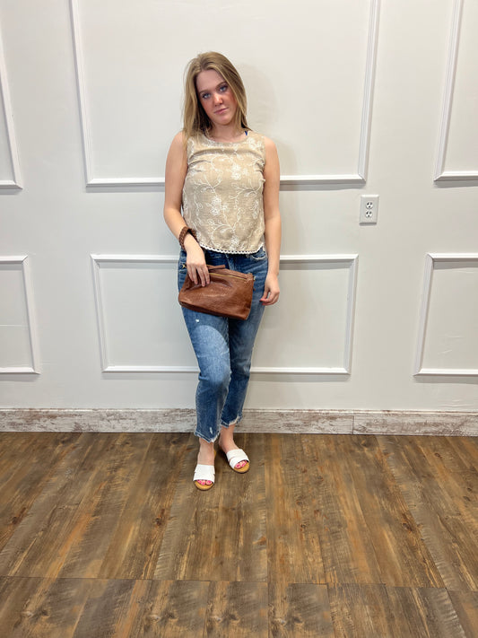 Person standing in a room with a white door and wooden floor.