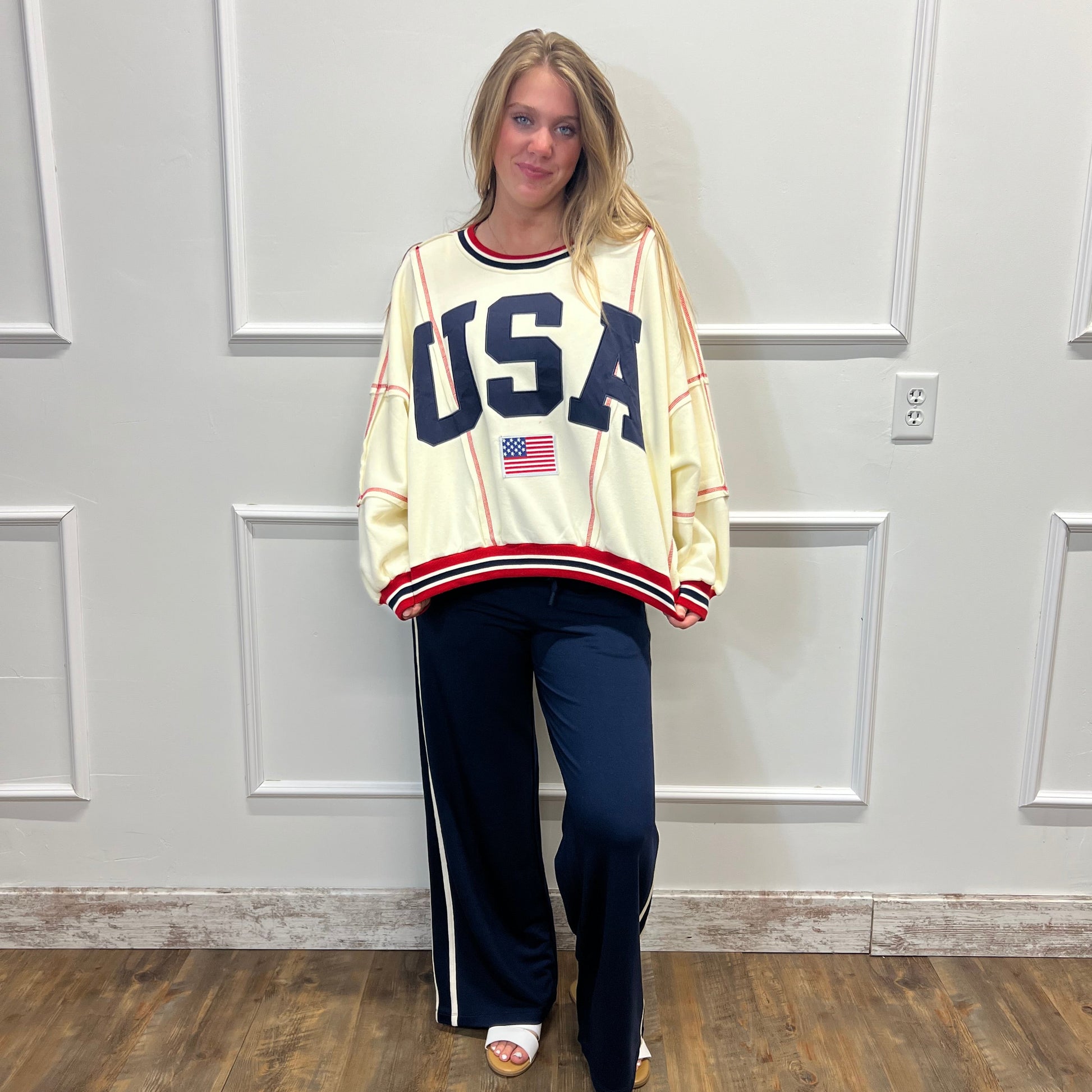 Person wearing a vintage-style 'USA' jersey standing in front of a white door.