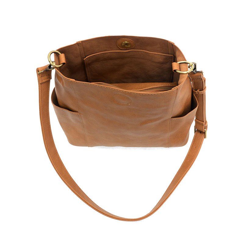 Brown leather handbag with a shoulder strap on a white background