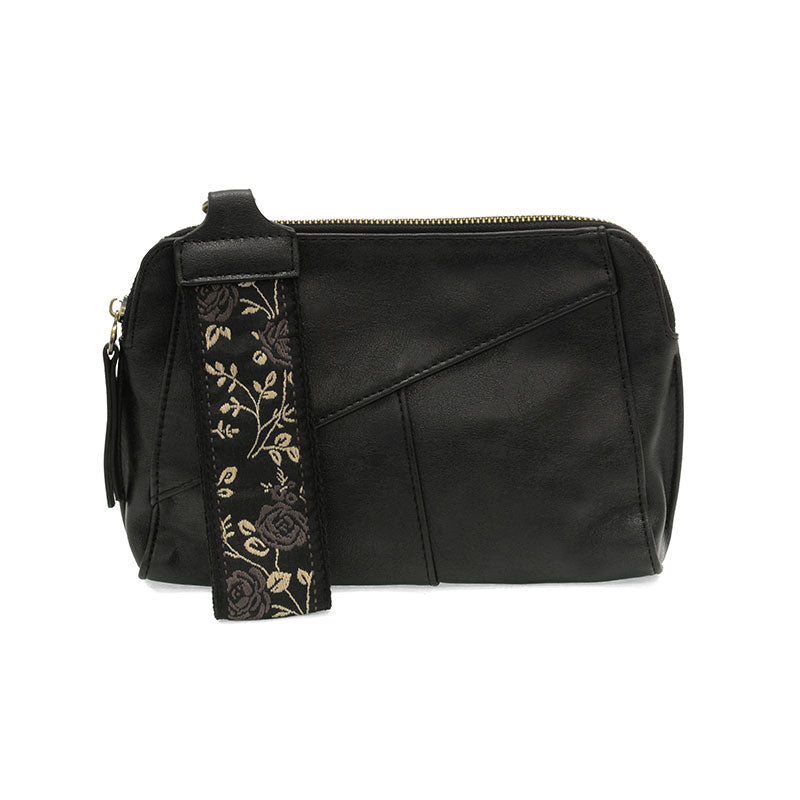 Black leather bag with a floral strap on a white background