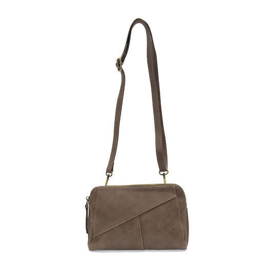 Brown suede handbag with a strap on a white background