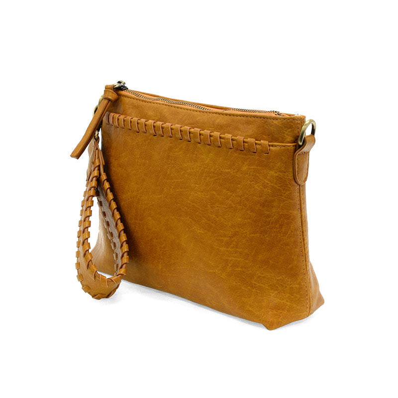 Brown leather handbag with a strap on a white background