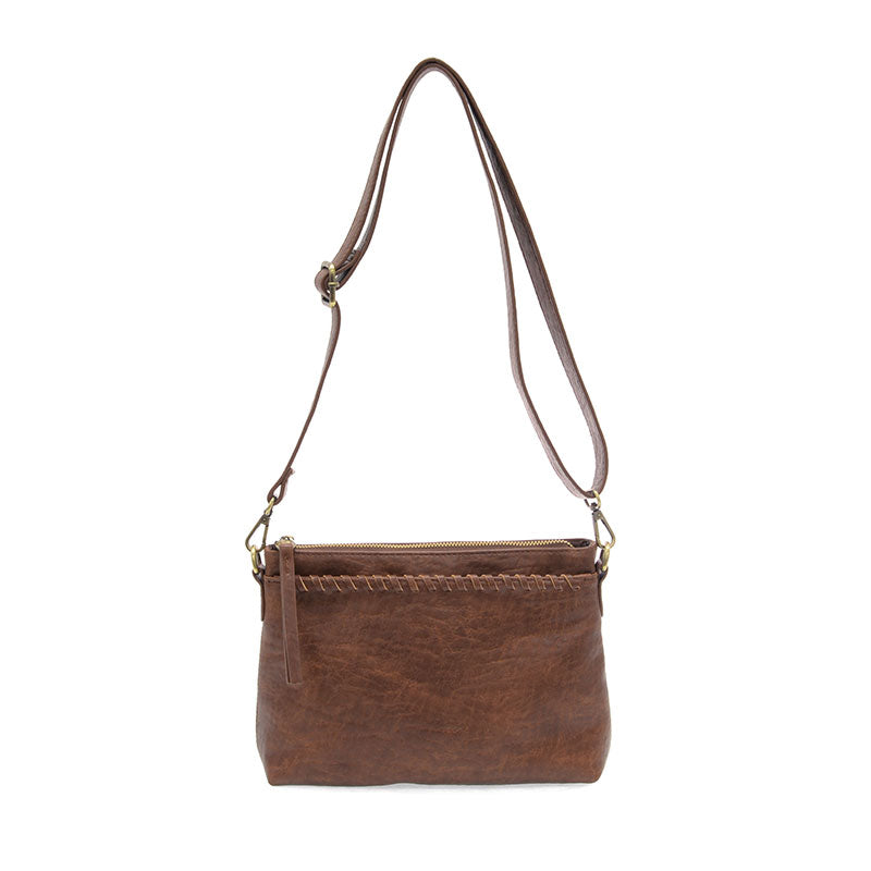 Brown leather handbag with a strap on a white background