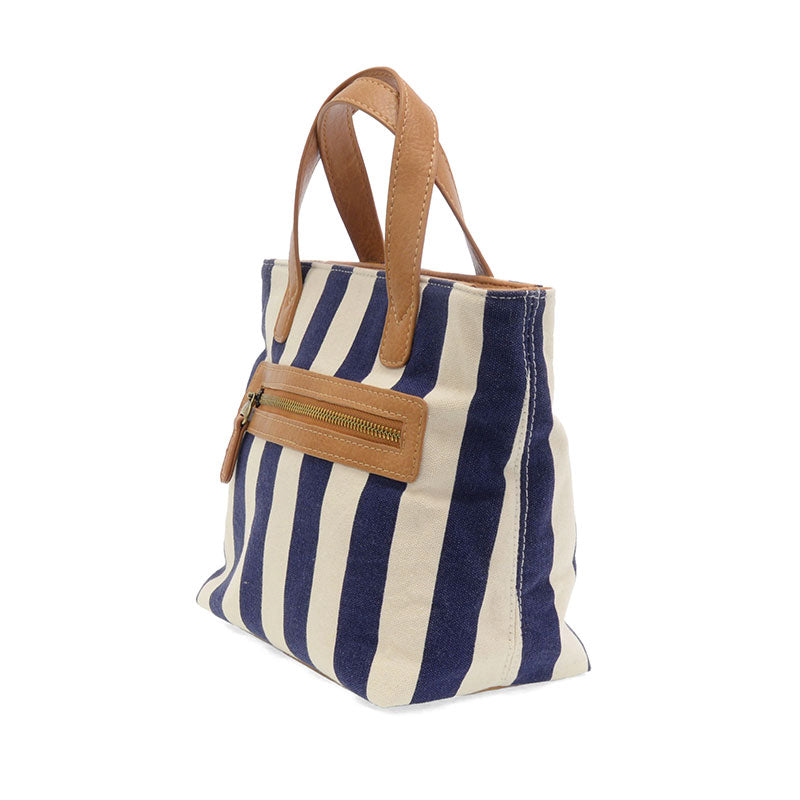 Navy and white striped tote bag with brown leather handle and pocket on a white background