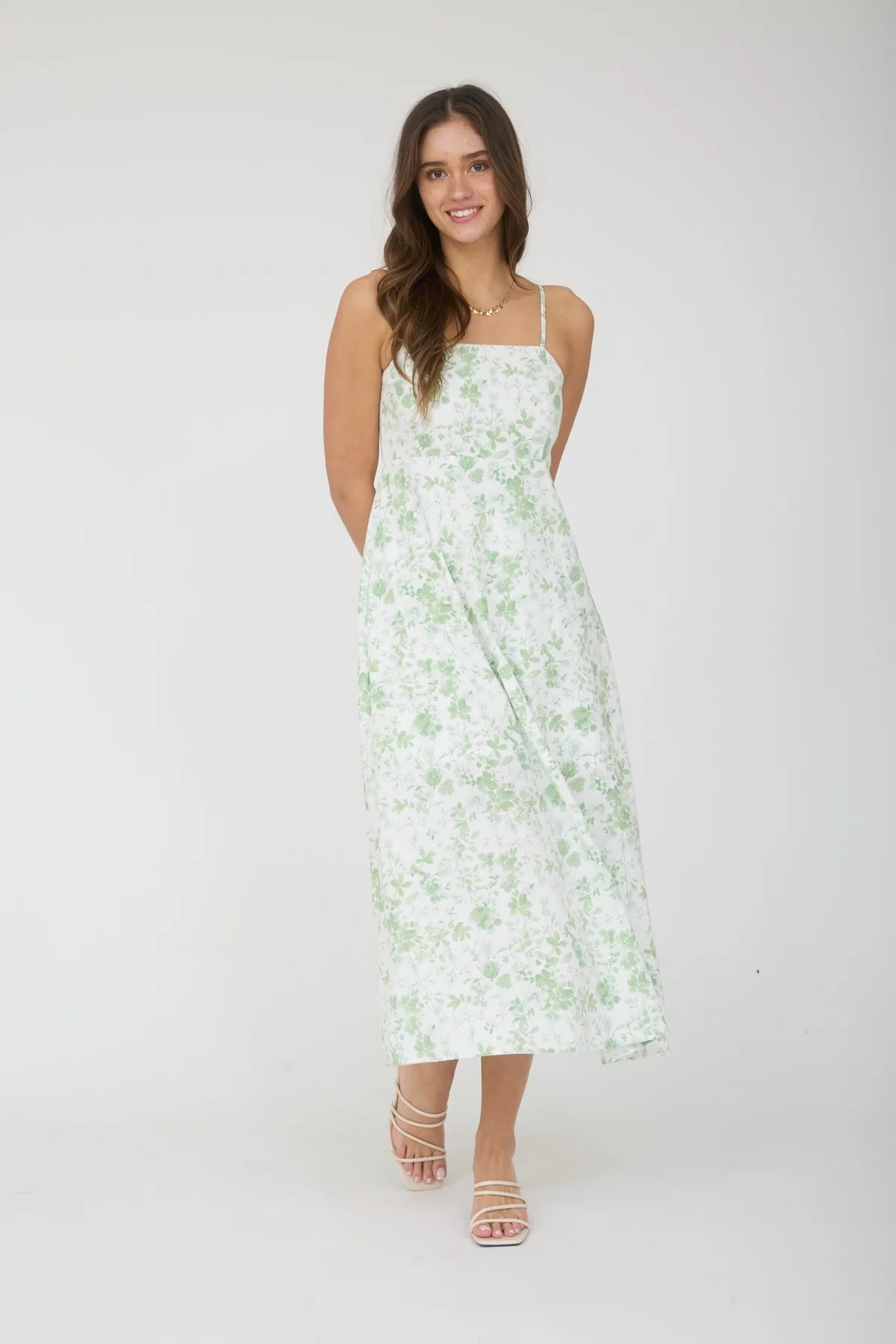 Woman wearing a floral dress on a white background