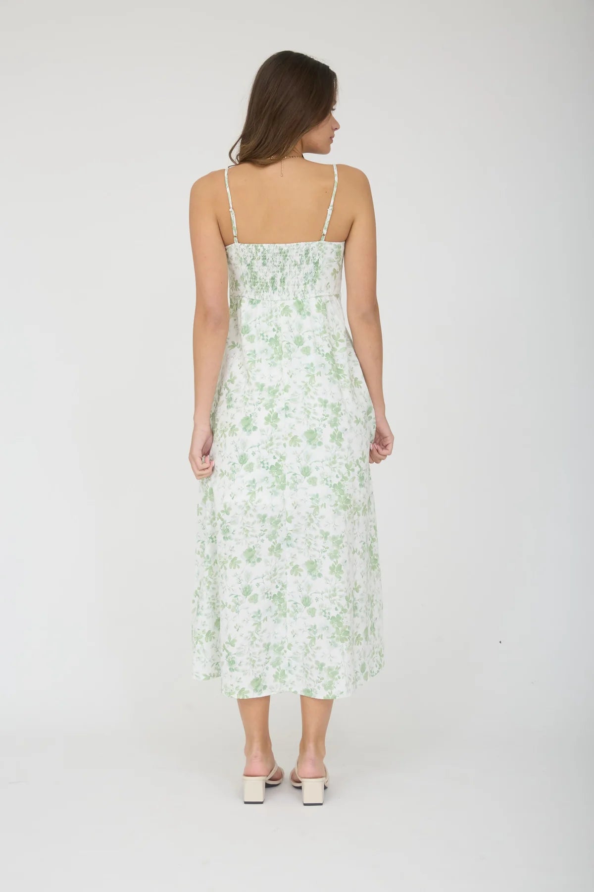 Woman wearing a floral dress on a white background