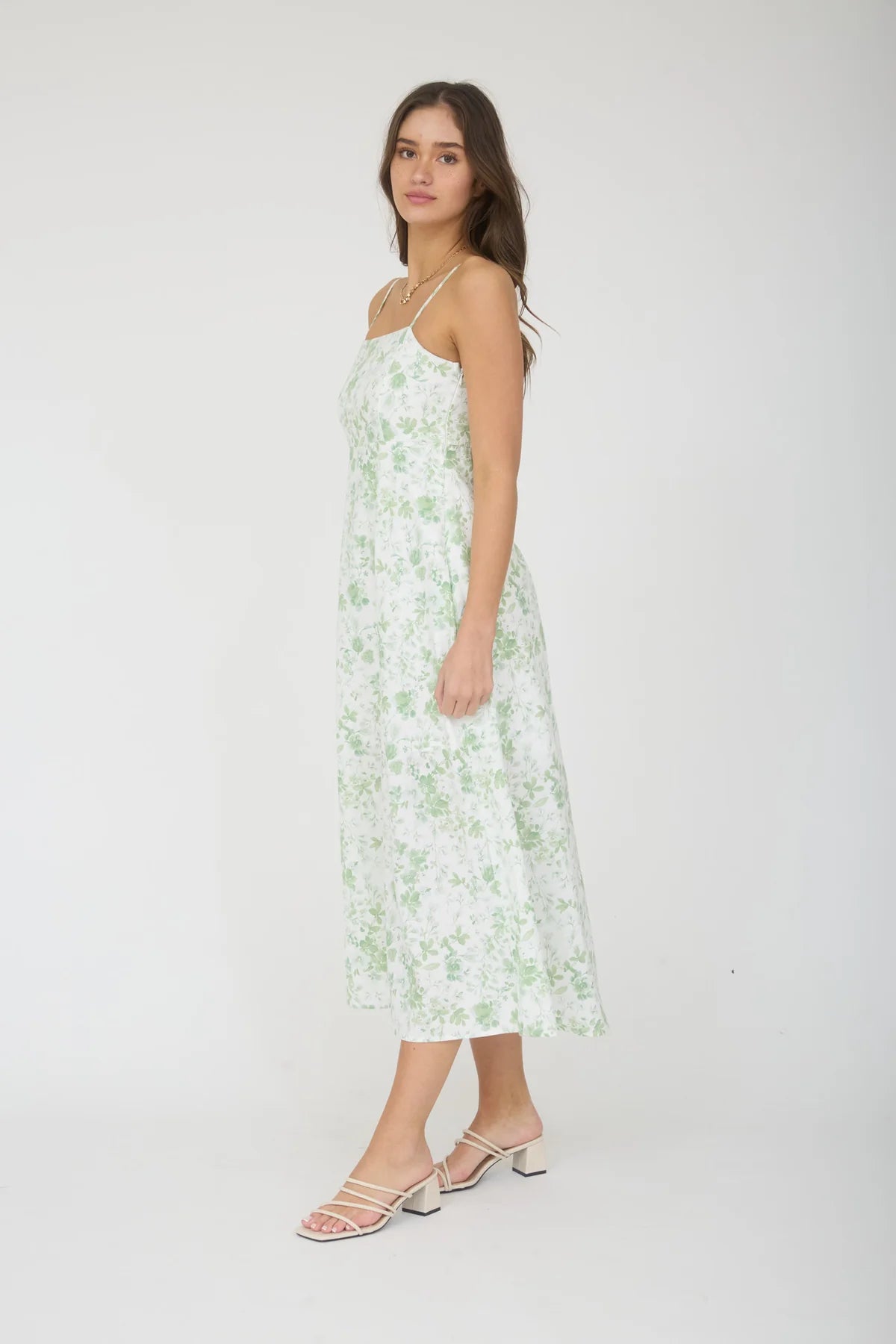 Woman wearing a floral dress on a white background