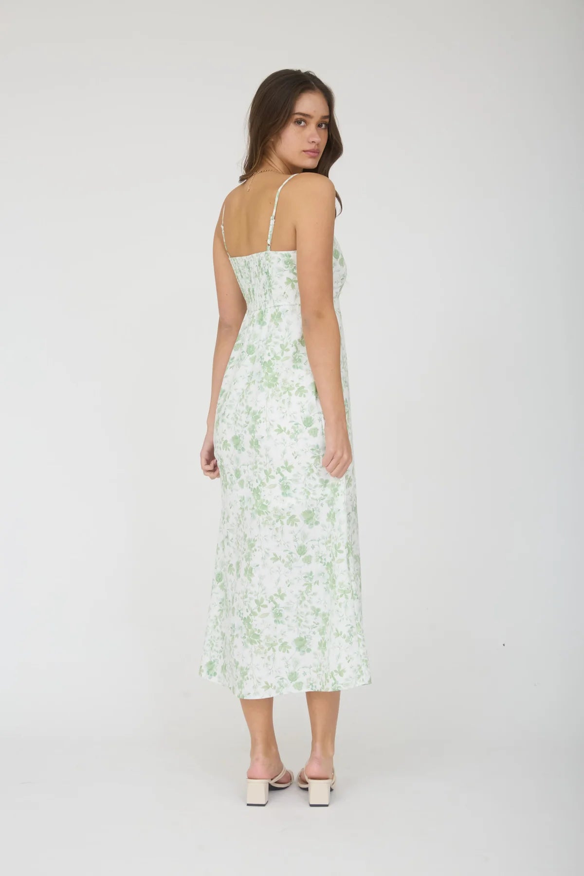 Woman wearing a floral dress on a white background