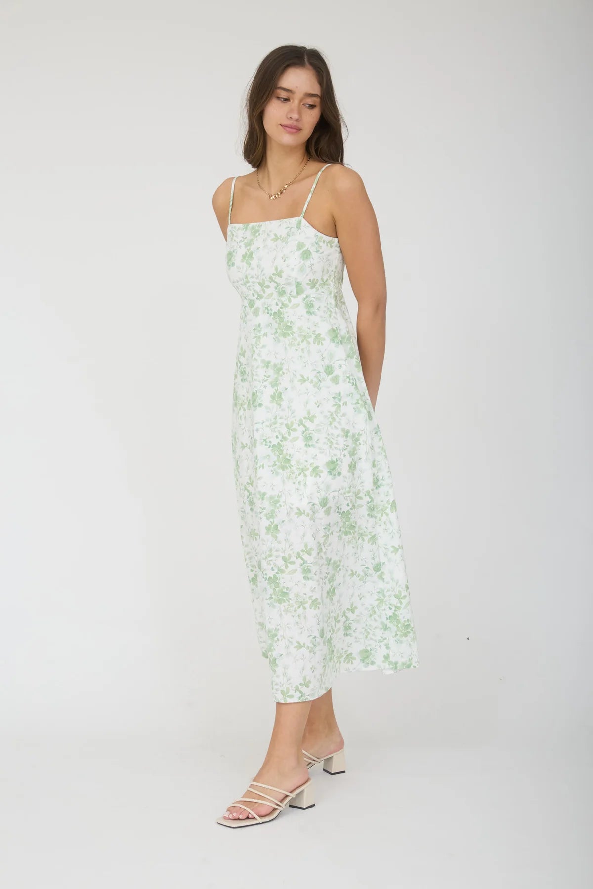 Woman wearing a floral dress on a white background