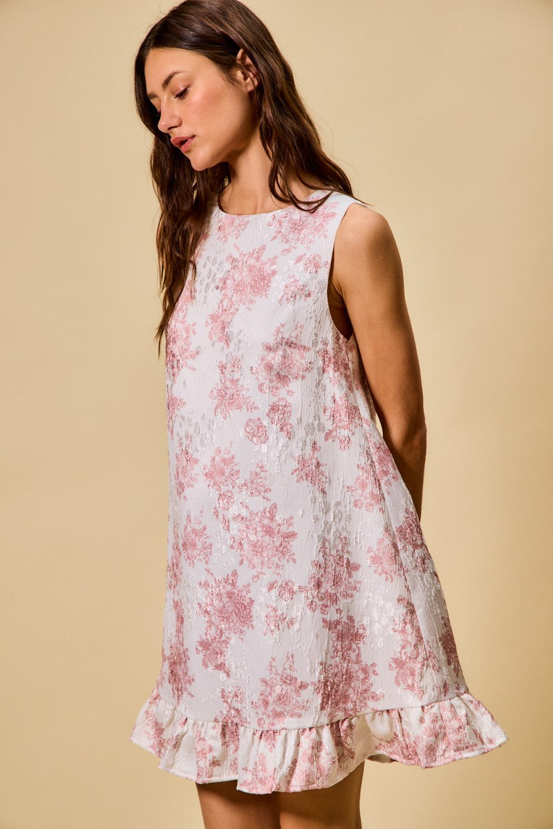 Woman wearing a floral dress against a beige background