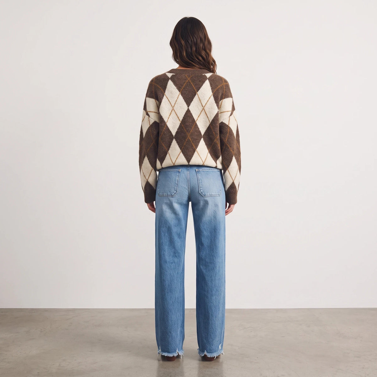 Apricot Lane Duluth brown and cream argyle knit sweater worn with light wash denim jeans, back view
