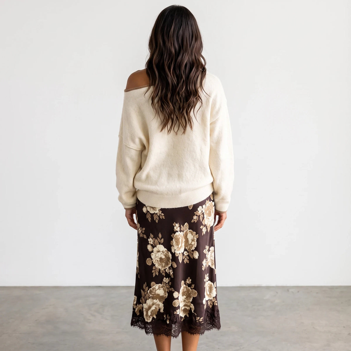 Apricot Lane Duluth Autumn Glow Sweater in cream worn with a brown floral midi skirt, back view on a model