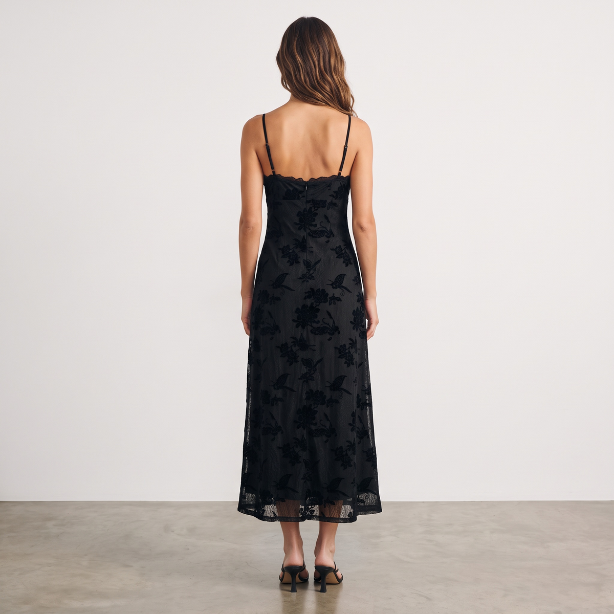 Back view of Apricot Lane Duluth Colette midi dress in black velvet floral burnout lace with spaghetti straps