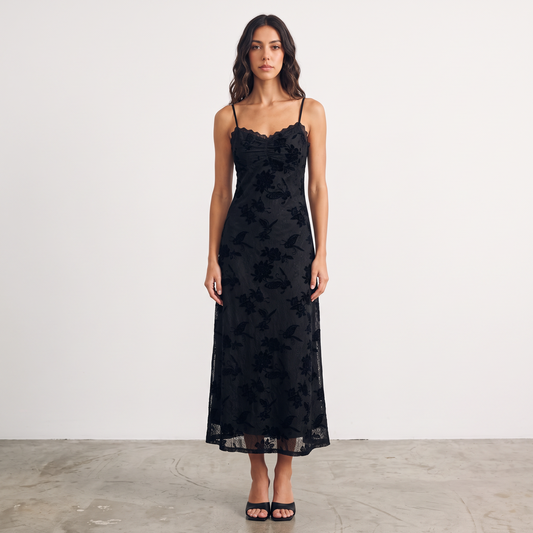 Model wearing Apricot Lane Duluth black floral velvet burnout midi slip dress with scalloped lace trim and spaghetti straps