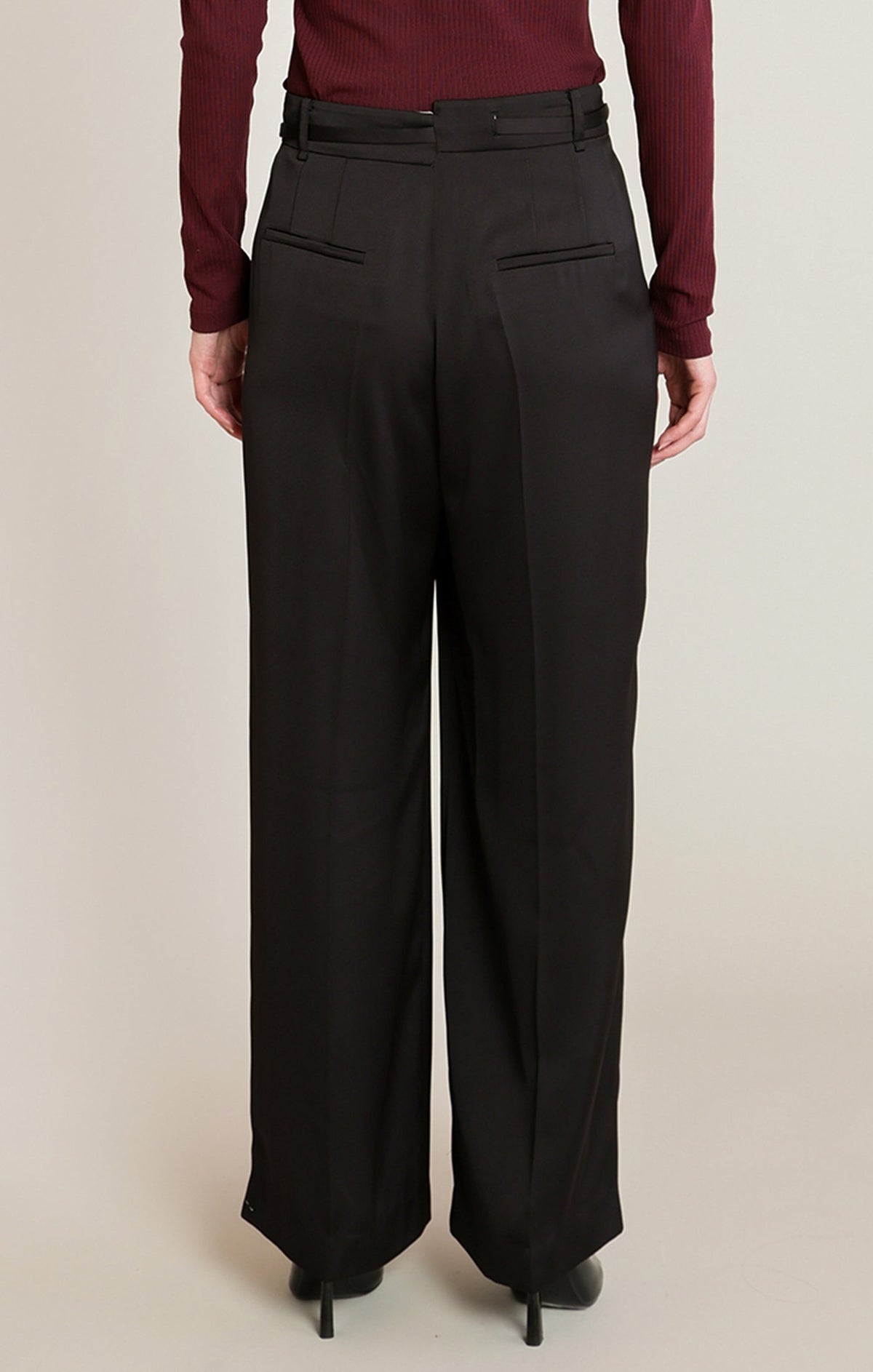 Back view of Apricot Lane Duluth Simone satin belted pants in black with a fluid drape and tailored pockets.