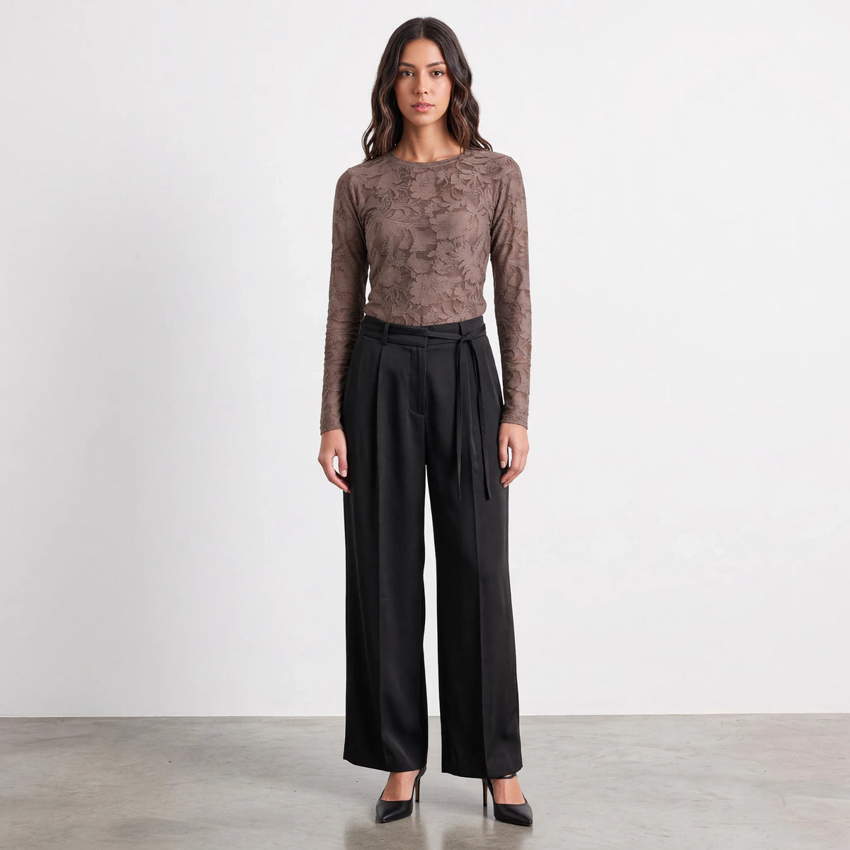 Apricot Lane Duluth Simone satin belted pants in black with a fluid drape, worn with a brown lace top and heels