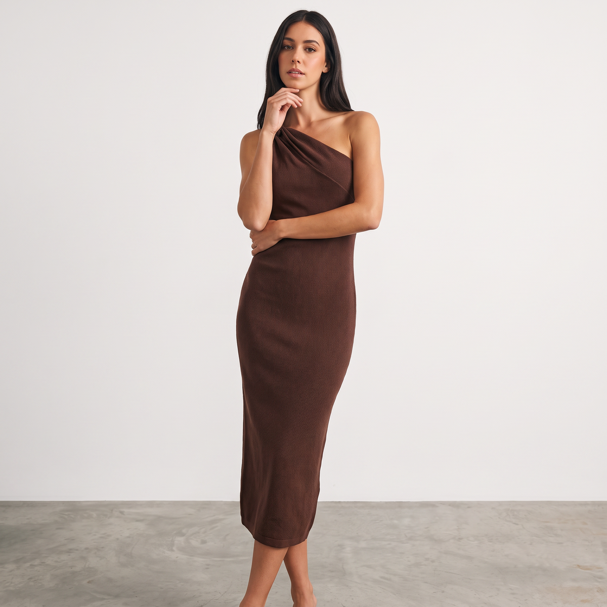 Model wearing Apricot Lane Duluth brown one-shoulder midi dress with a textured knit fabric and cutout detail.